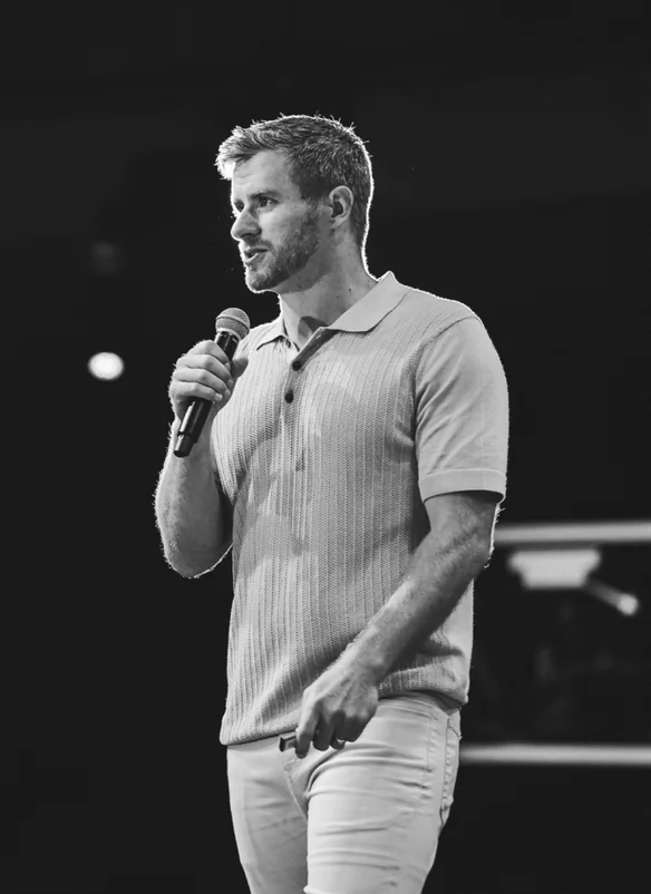 Nathan Barry speaking on stage with a microphone